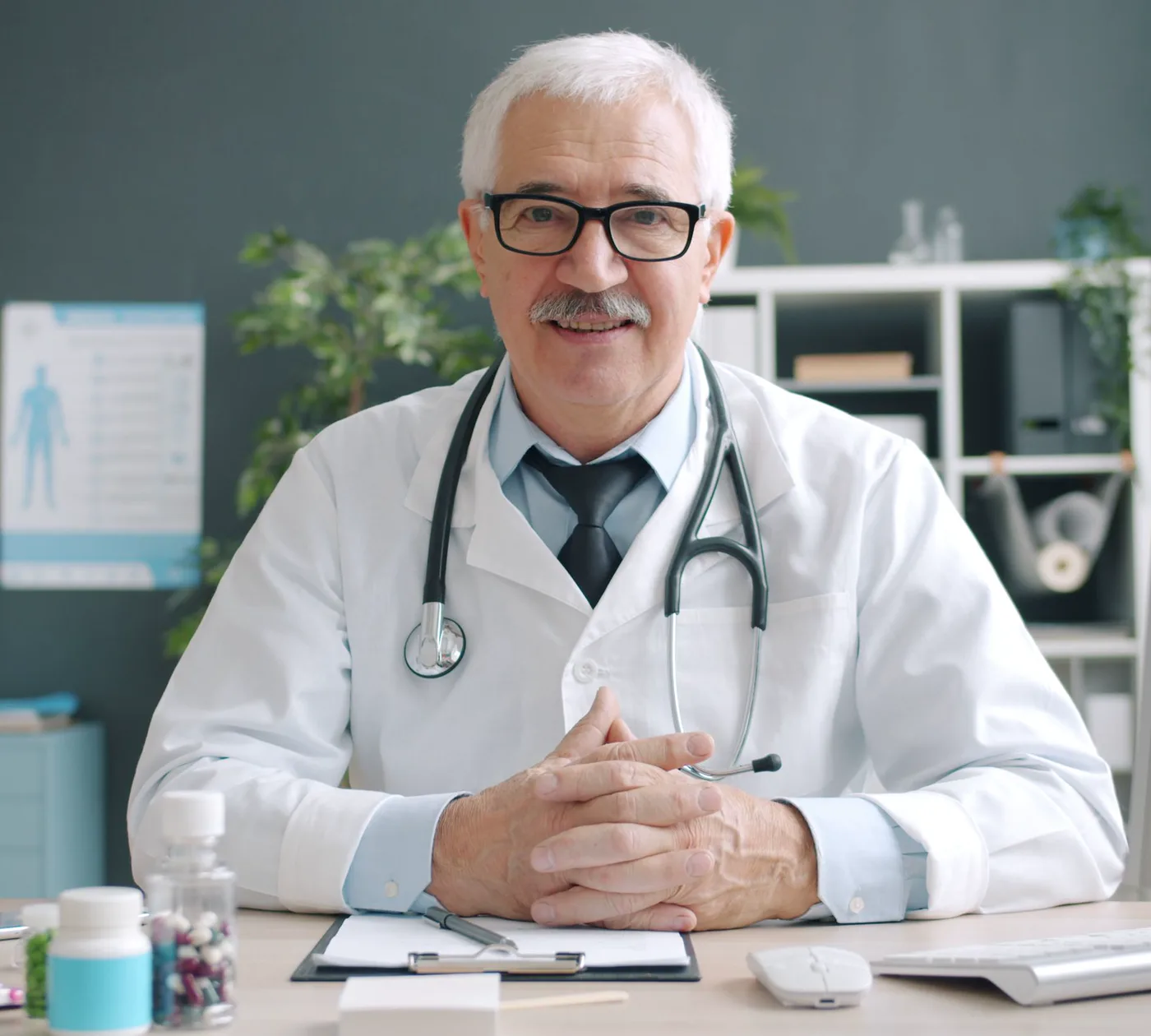 Dr. Anil Khanna at his desk, in a white coat with a stethoscope