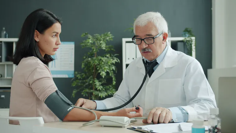 Dr. Khanna checking a patient's blood pressure