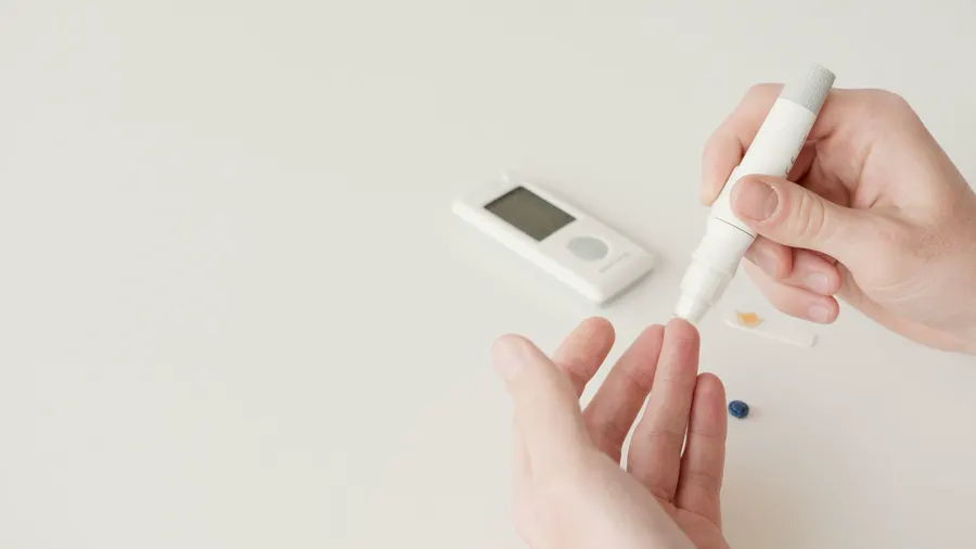 A blood sugar meter and a finger-prick pen